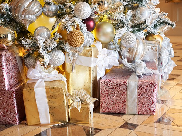 Wrapped holiday presents underneath a decorated Christmas tree