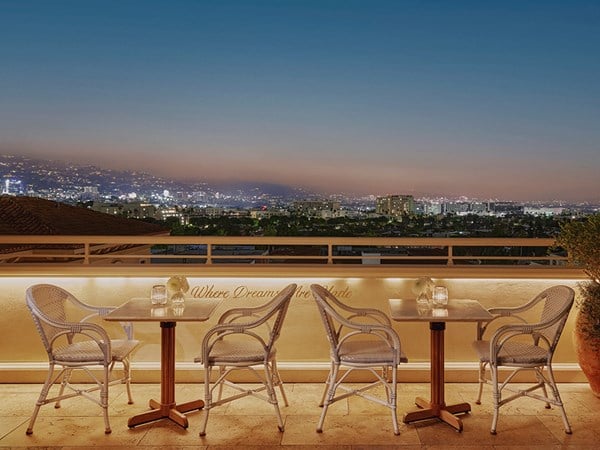 Rooftop dining with a view of the night skyline