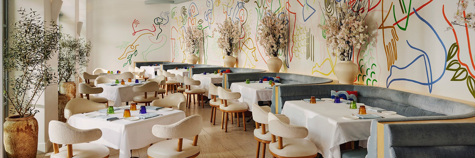A restaurant's dining space showcases trendy decor with wall graffiti, enhancing its distinctive character.