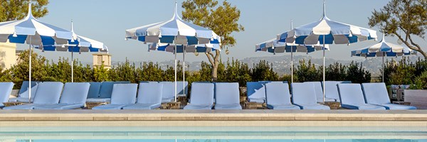 Rooftop pool with white and blue umbrellas