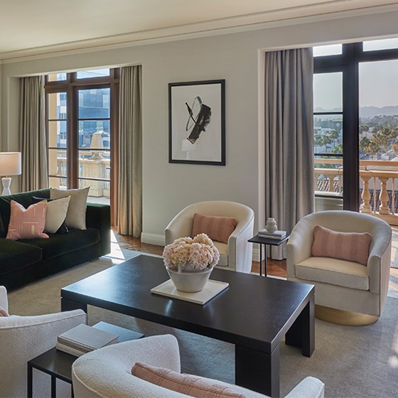 Plush sofas and armchairs in living room with terrace doors open in The Residence